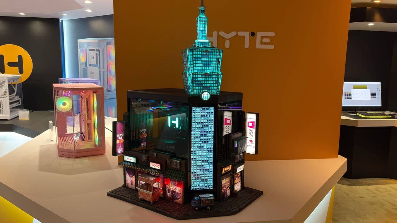 This skyscraper-shaped custom PC at Computex has a food stall out the front selling 'Taiwanese sausage with sticky rice' and a rock climber free soloing up the side